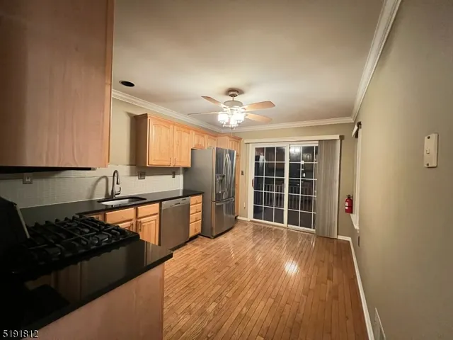 a large kitchen with granite countertop a stove and a sink
