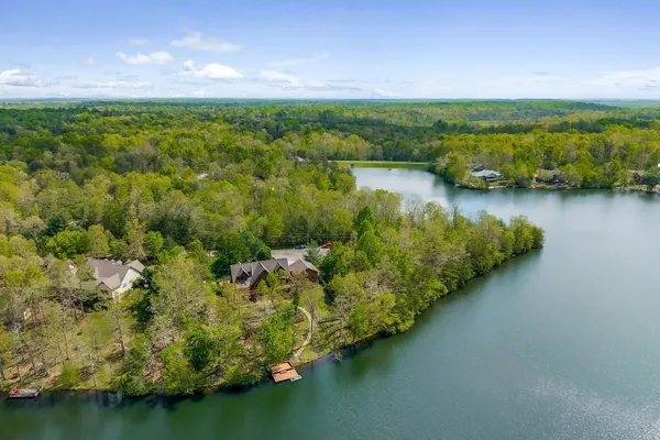 a view of a lake with houses in the back