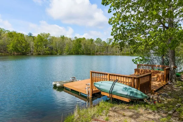 a view of a lake with a bench in the background