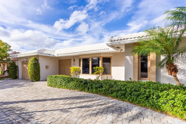 a kitchen with white cabinets and appliances