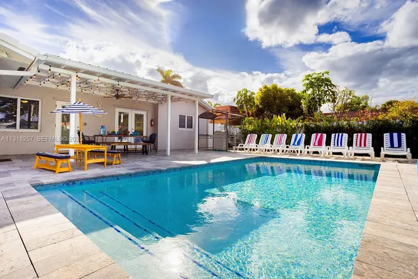 a view of a swimming pool with an outdoor seating