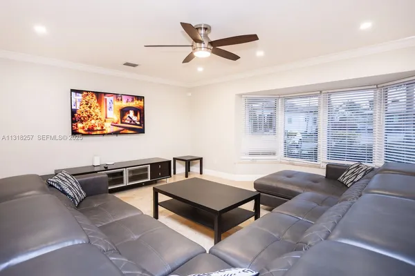 a living room with furniture and a large window