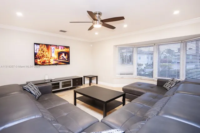 a bedroom with two beds and a flat screen tv