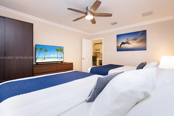 a bedroom with a bed and a painting on the wall