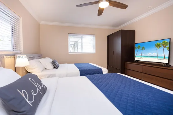 a bedroom with a large bed and a painting on the wall