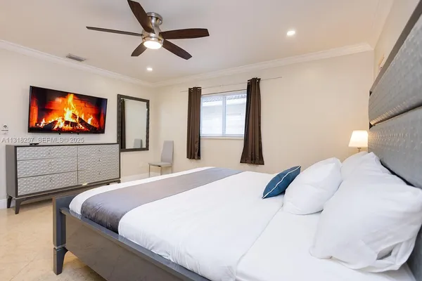 a bedroom with a bed and a chandelier