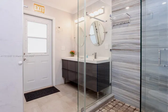 a spacious bedroom with a bed and a chandelier