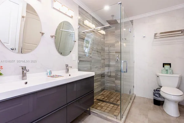 a bathroom with a sink toilet and shower