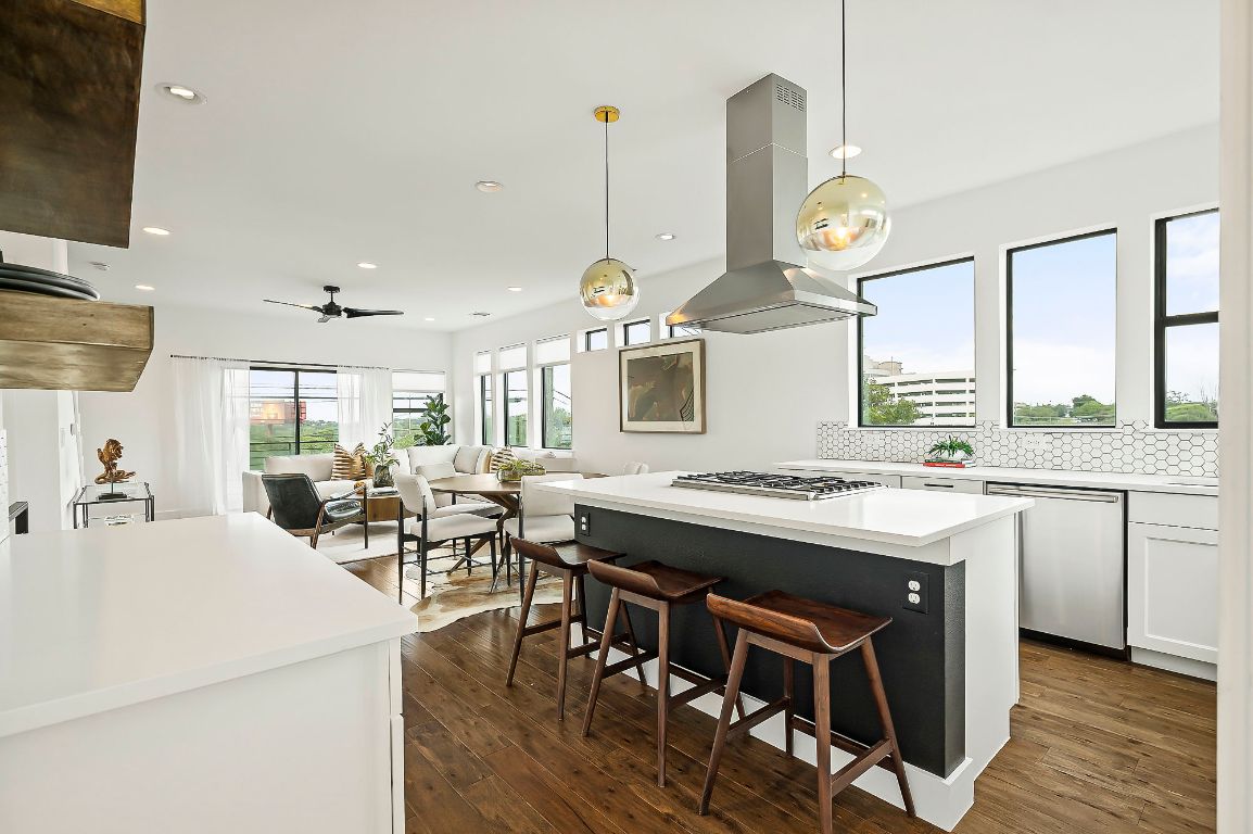 1104 Marcy Street, Unit B Austin, TX 78745 - Photo 13 of 38 a kitchen with a stove a counter space dining table and chairs