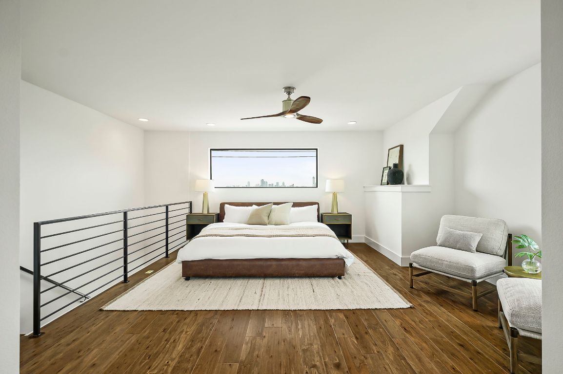 1104 Marcy Street, Unit B Austin, TX 78745 - Photo 17 of 38 a spacious bedroom with a bed a couch and a window