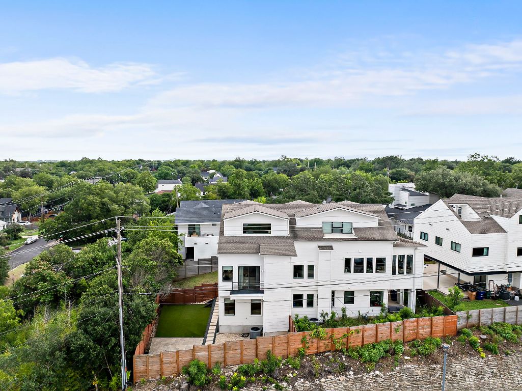 1104 Marcy Street, Unit B Austin, TX 78745 - Photo 31 of 38 a view of a white house with a big yard and large trees