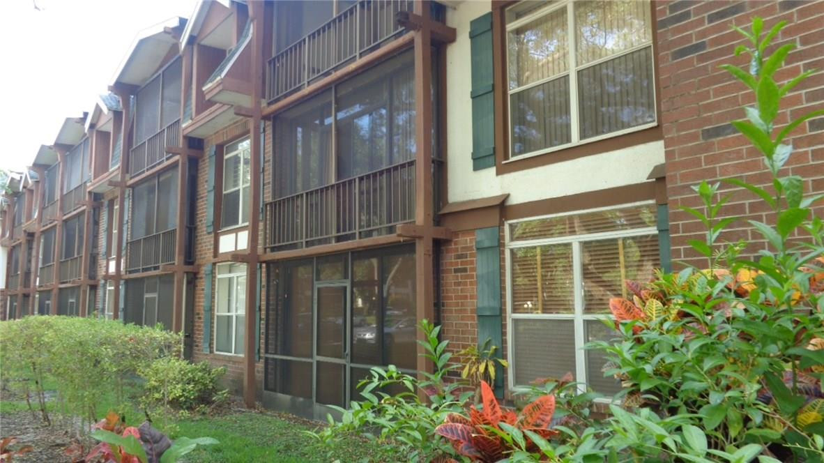 3670 Inverrary Drive, Unit 2C Lauderhill, FL 33319 - Photo 3 of 21 a flower garden on the side of a building