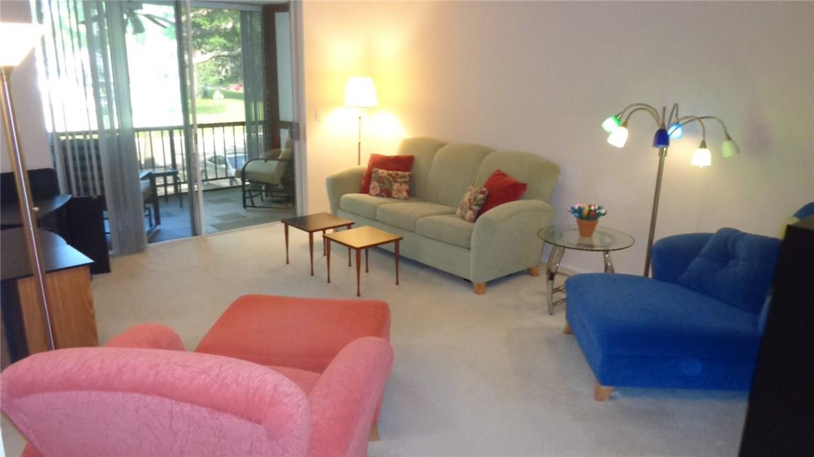 3670 Inverrary Drive, Unit 2C Lauderhill, FL 33319 - Photo 4 of 21 a living room with furniture and a lamp