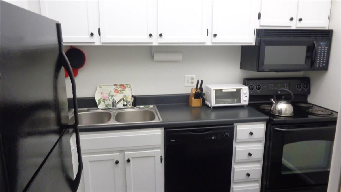 3670 Inverrary Drive, Unit 2C Lauderhill, FL 33319 - Photo 5 of 21 a kitchen with a sink and cabinets