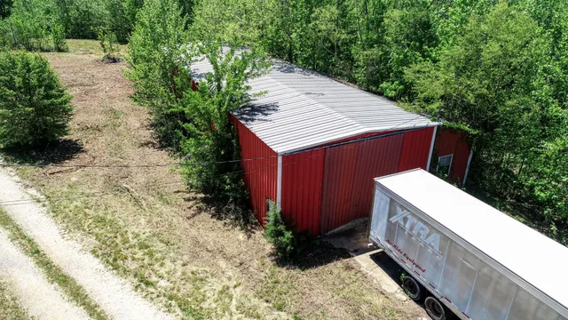 an aerial view of a house with a garden and lake view