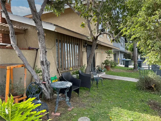 a view of backyard of house with outdoor seating