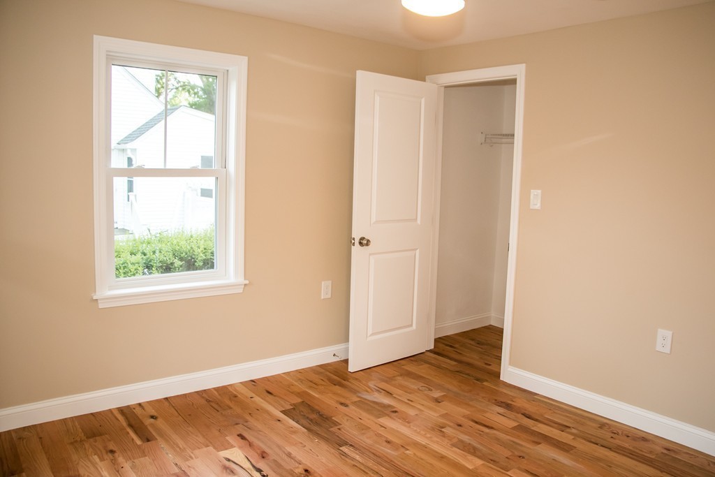6 Walnut Road Chelmsford, MA 01824 - Photo 15 of 23 a view of an empty room with wooden floor and a window