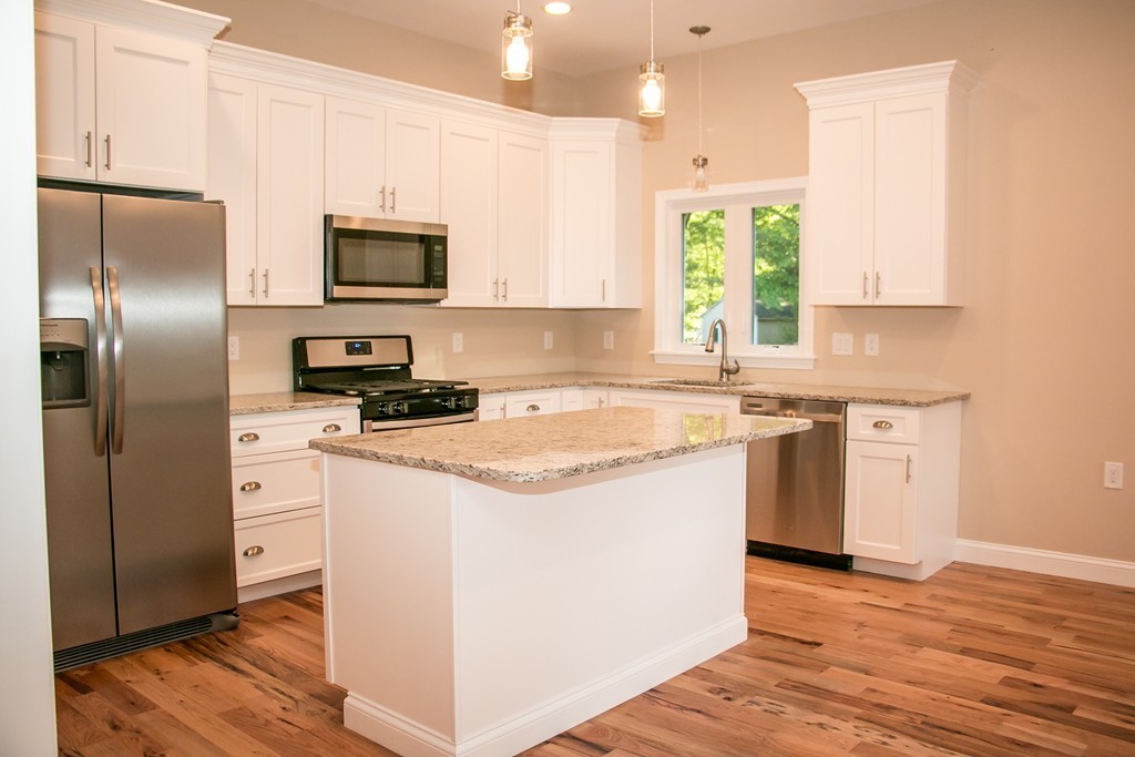 6 Walnut Road Chelmsford, MA 01824 - Photo 3 of 23 a kitchen with stainless steel appliances granite countertop a stove a sink and a refrigerator