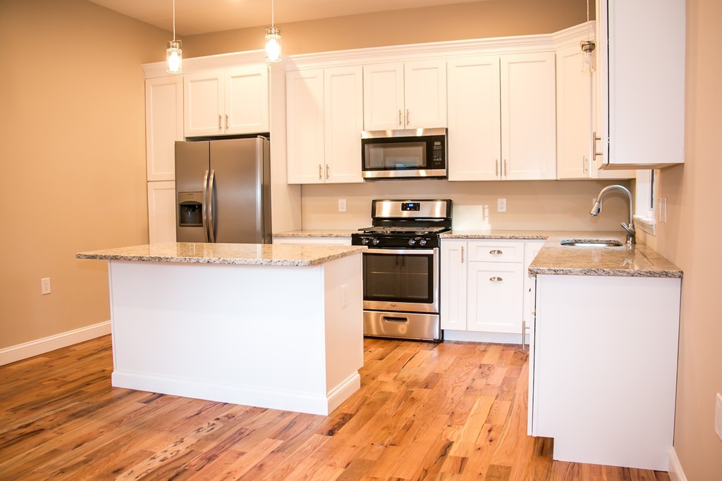 6 Walnut Road Chelmsford, MA 01824 - Photo 4 of 23 a kitchen with stainless steel appliances a stove refrigerator and microwave