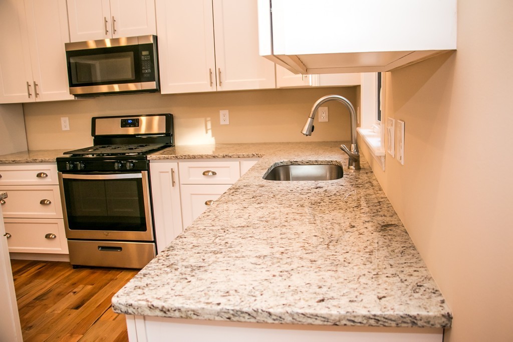 6 Walnut Road Chelmsford, MA 01824 - Photo 5 of 23 a kitchen with a stove and a microwave