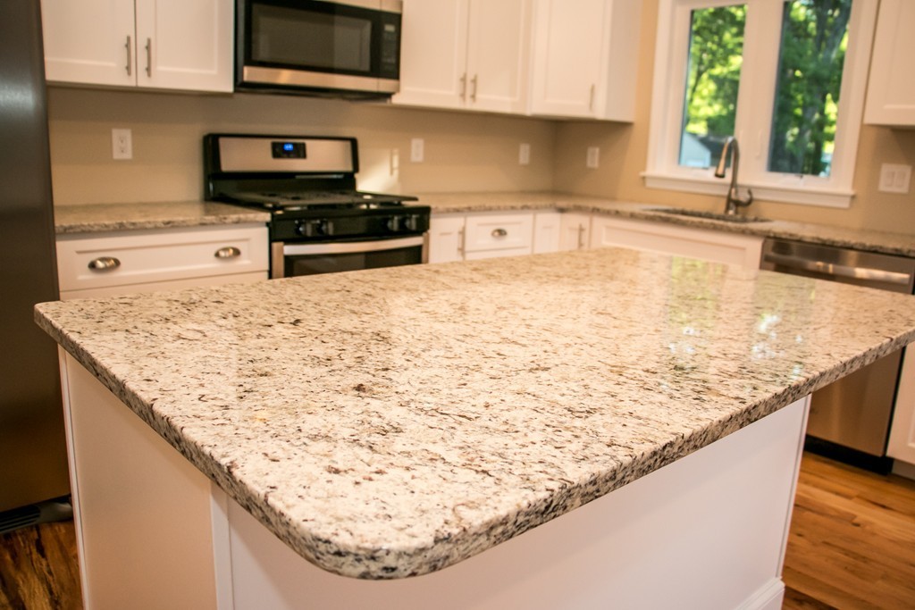 6 Walnut Road Chelmsford, MA 01824 - Photo 6 of 23 a kitchen with stainless steel appliances granite countertop a sink stove and microwave