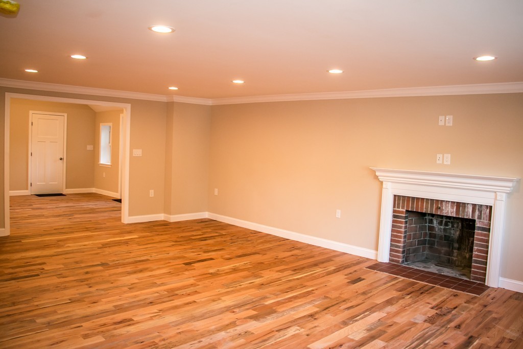 6 Walnut Road Chelmsford, MA 01824 - Photo 8 of 23 a view of an empty room with wooden floor fireplace and a window