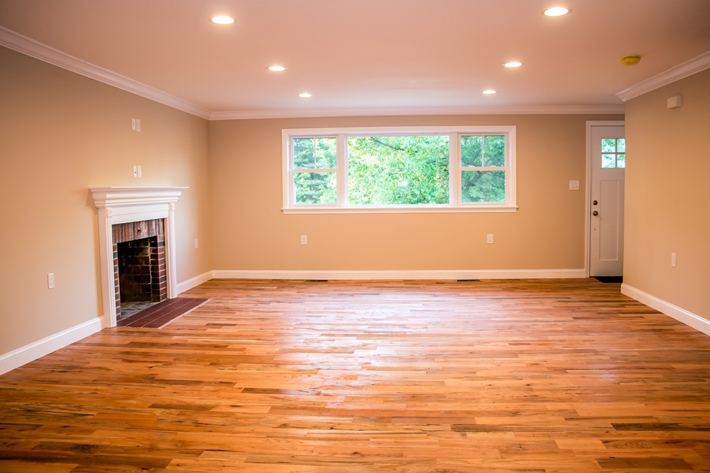 6 Walnut Road Chelmsford, MA 01824 - Photo 9 of 23 an empty room with wooden floor fireplace and windows