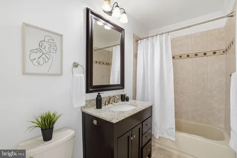 a bathroom with a sink vanity and a mirror