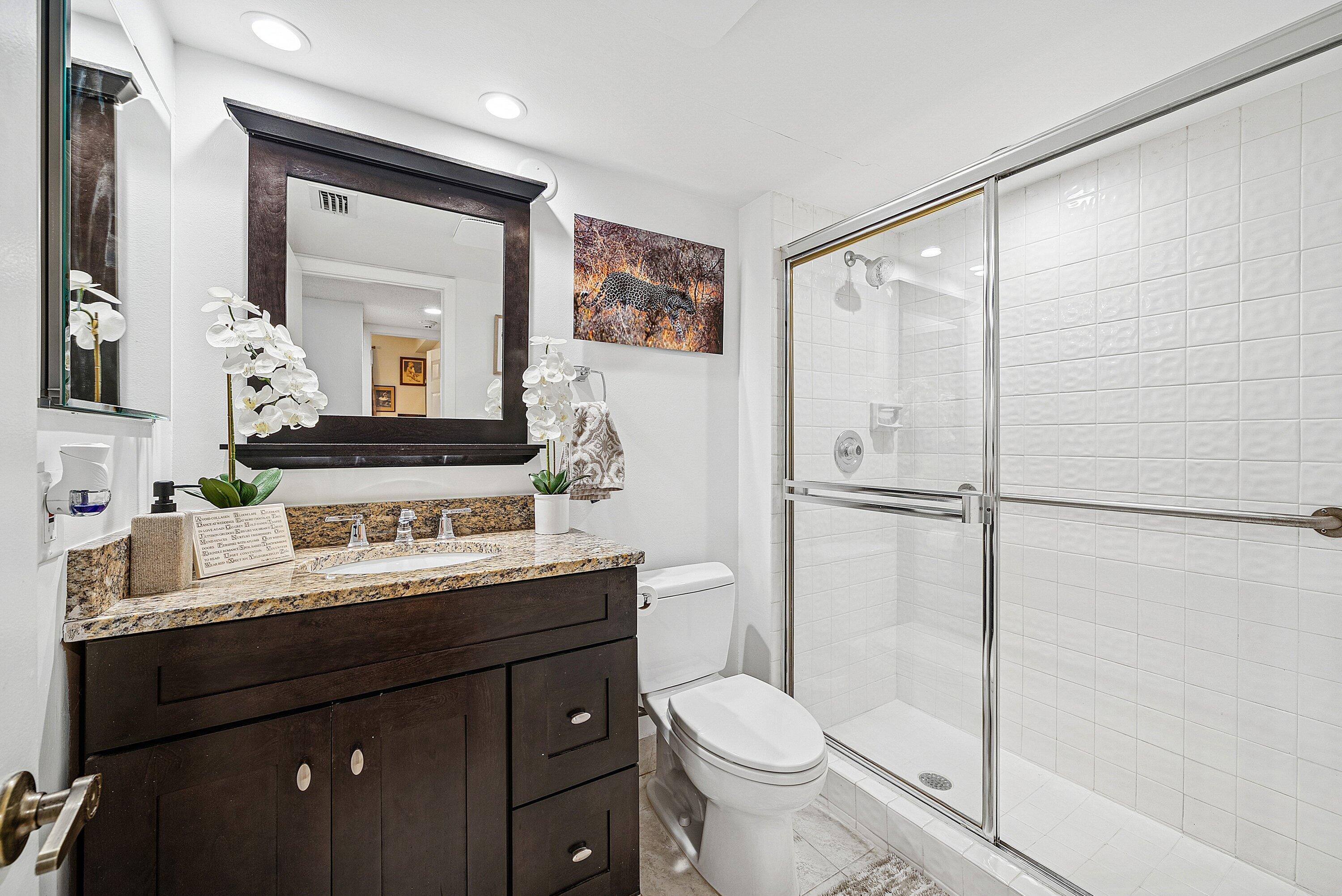 7933 La Mirada Drive Boca Raton, FL 33433 - Photo 19 of 33 a bathroom with a double vanity sink toilet mirror and shower