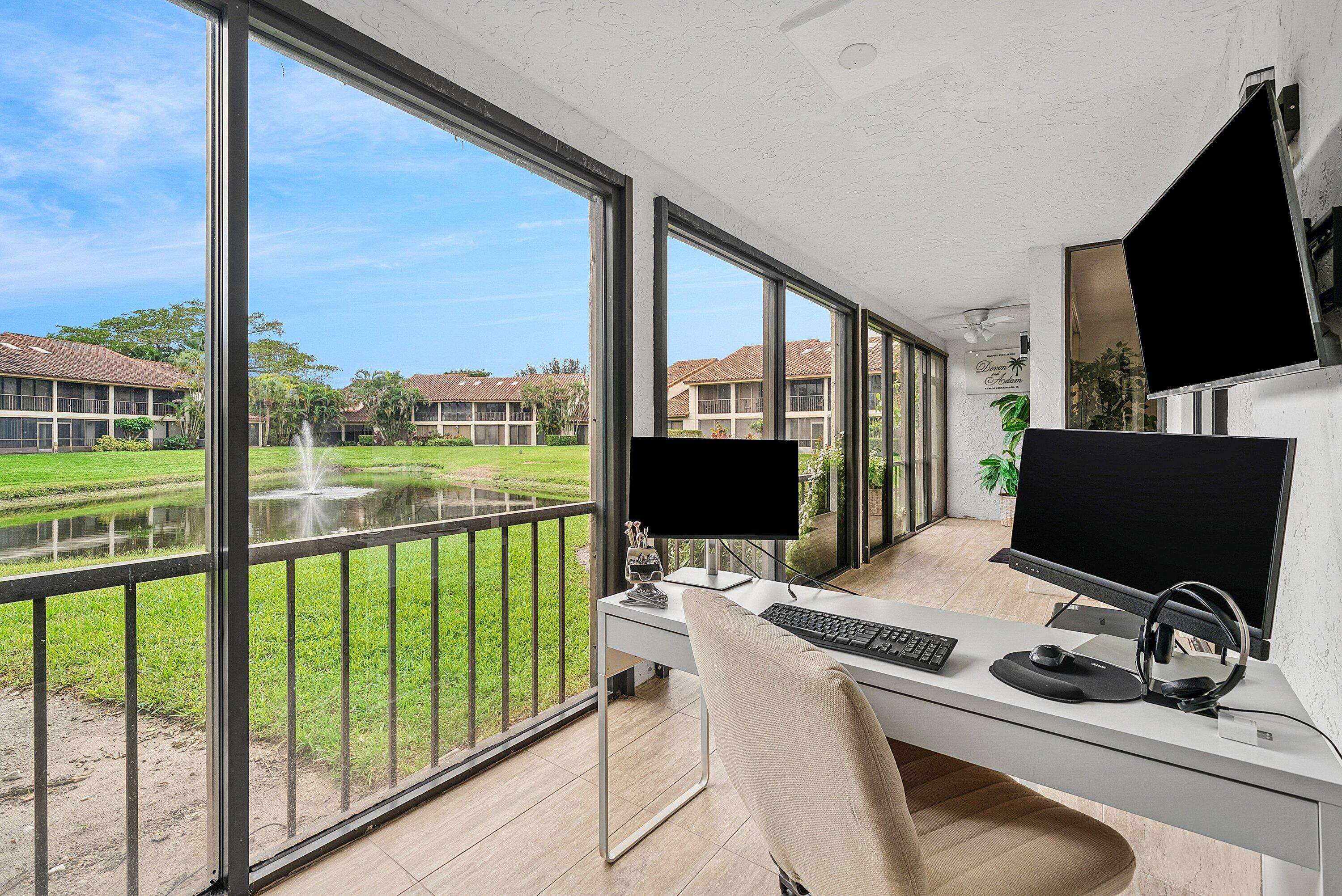 7933 La Mirada Drive Boca Raton, FL 33433 - Photo 26 of 33 a view of a workspace with furniture and floor to ceiling window