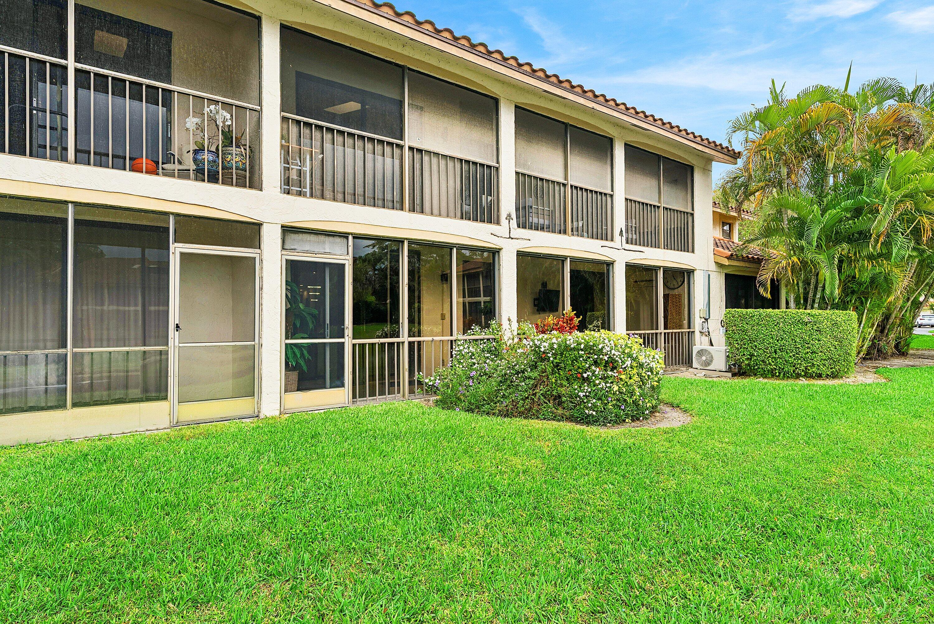 7933 La Mirada Drive Boca Raton, FL 33433 - Photo 27 of 33 a large building with a garden