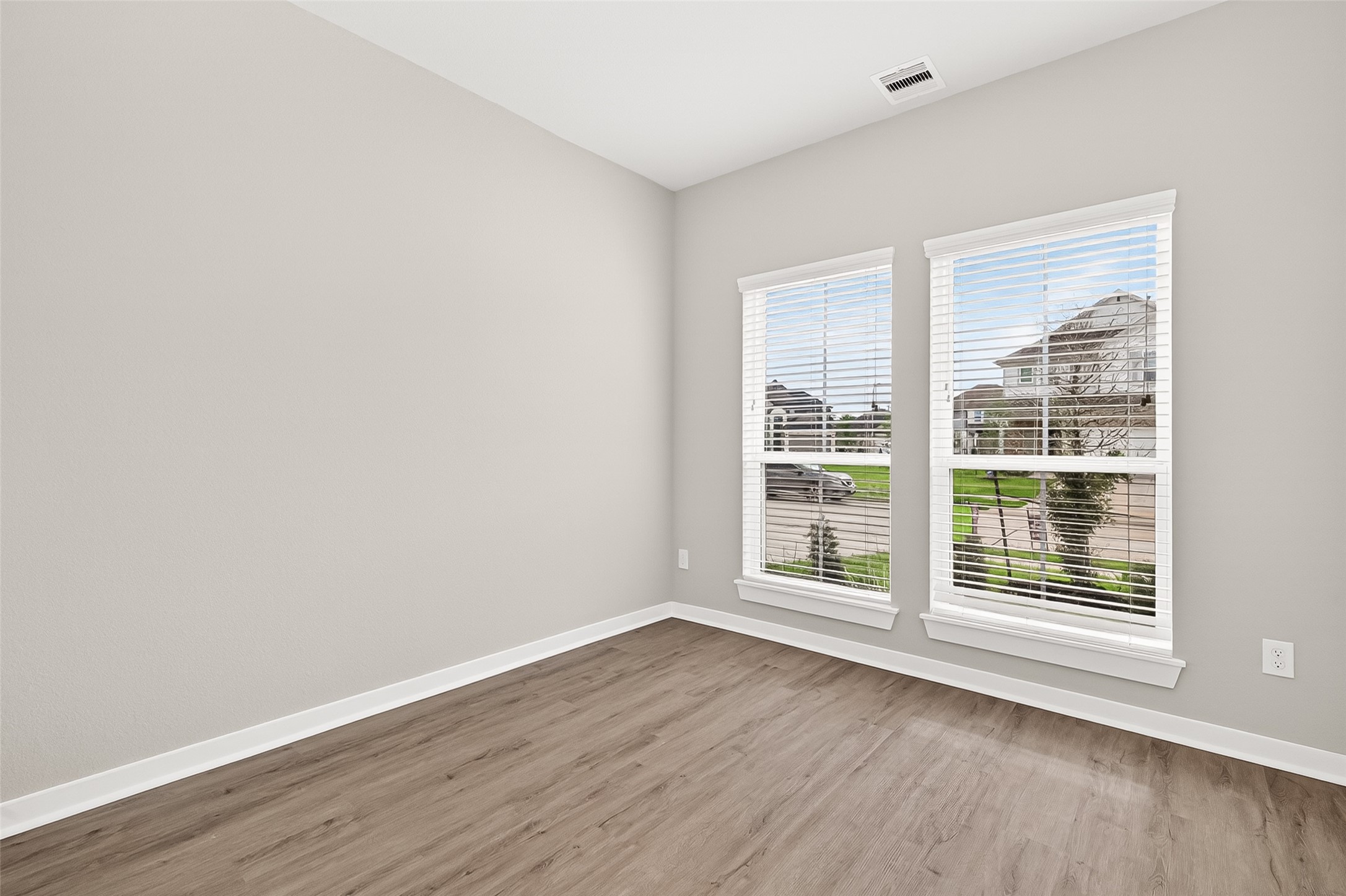 2142 Reed Cave Lane Spring, TX 77386 - Photo 7 of 50 an empty room with wooden floor and windows