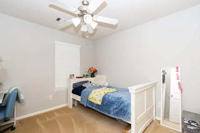 a bedroom with a bed and a chandelier