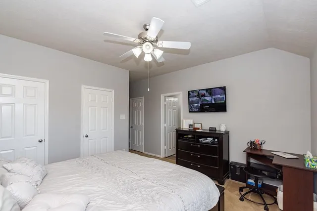 a bedroom with a bed and a chandelier