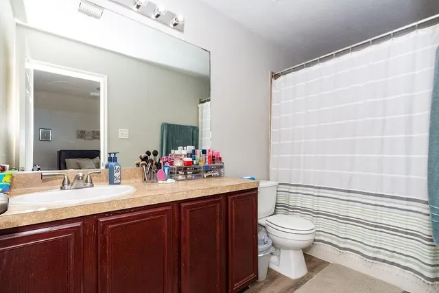 a bathroom with a sink toilet and shower