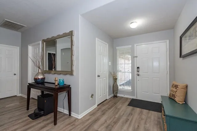 a room with wooden floor and furniture