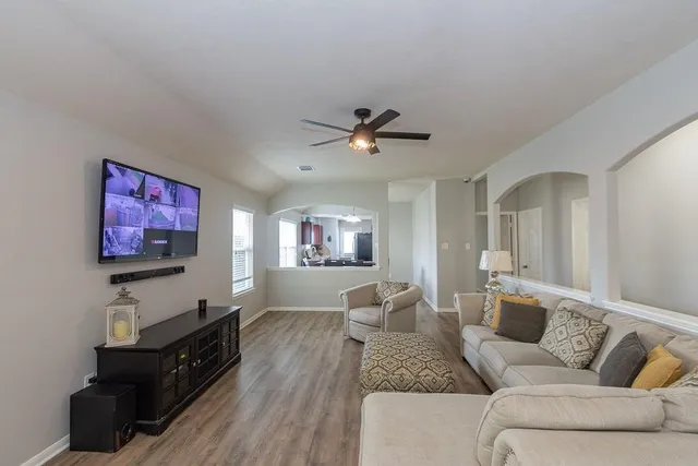 a living room with furniture and a flat screen tv
