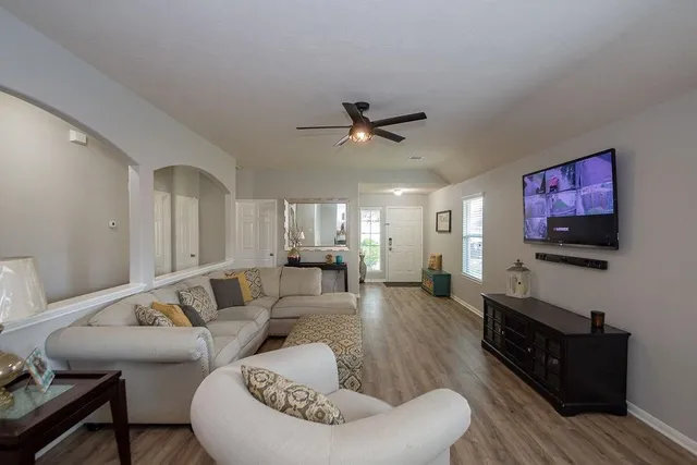 a living room with furniture and a flat screen tv