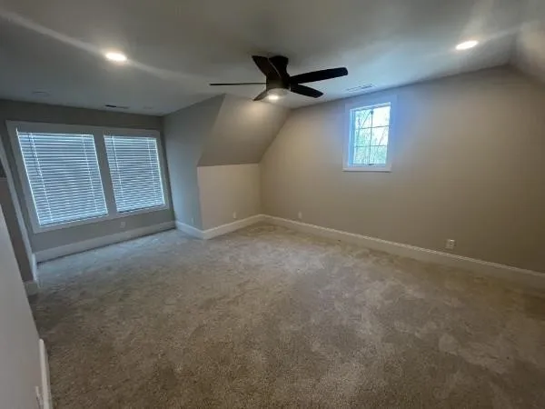 a large kitchen with a refrigerator and a stove top oven