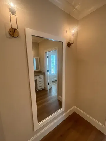 a view of a room with wooden floors and led lights