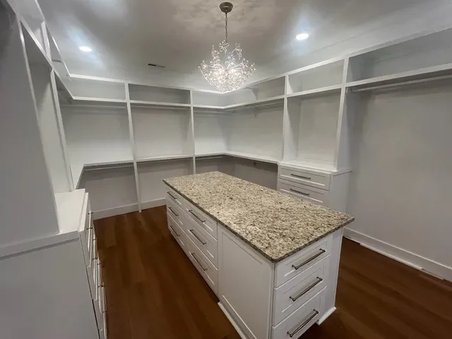 a large kitchen with stainless steel appliances granite countertop a stove a sink and a refrigerator