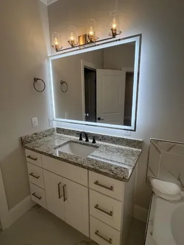 a bathroom with a shower and a mirror
