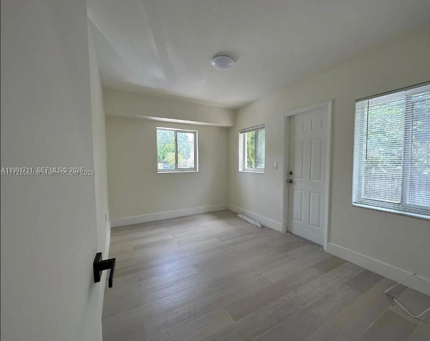 1514 Southwest 6th Street, Unit 4 Miami, FL 33135 - Photo 2 of 6 an empty room with windows