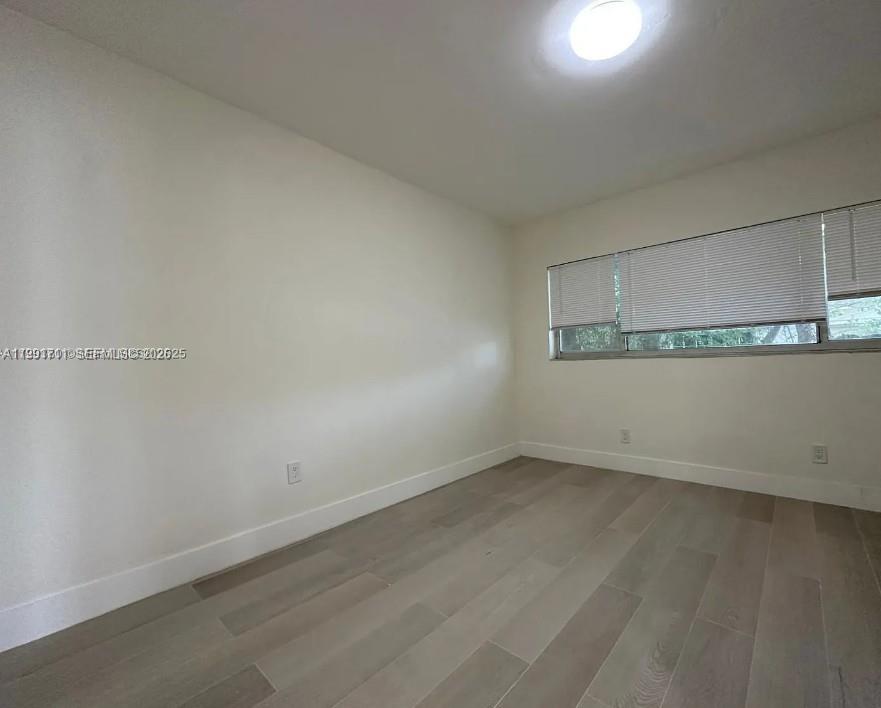 1514 Southwest 6th Street, Unit 4 Miami, FL 33135 - Photo 4 of 6 an empty room with a bench