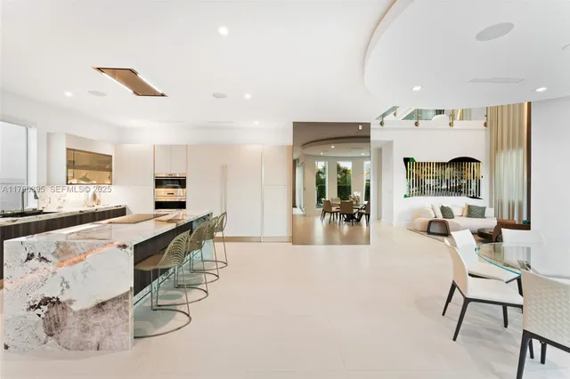 a room with lots of table chair and couches