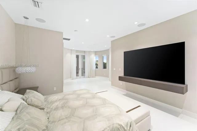 a bedroom with a bed and a flat screen tv