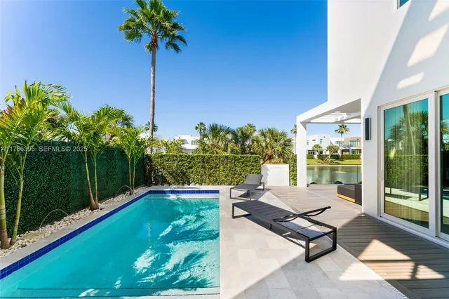 a swimming pool view with a garden space