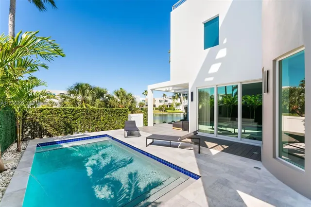 a view of a house with backyard sitting area and garden