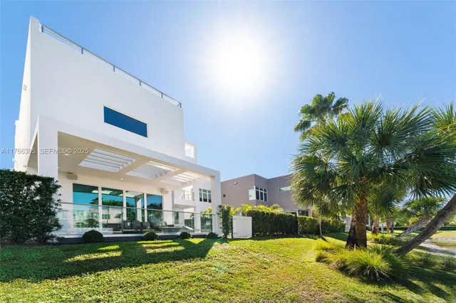 a living room with patio furniture and a large window