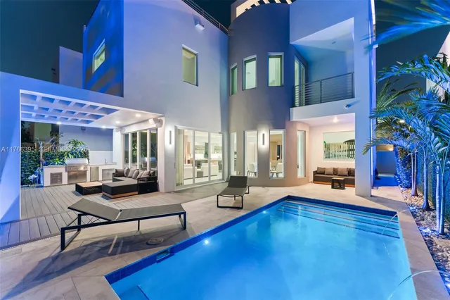 a swimming pool with outdoor seating and yard